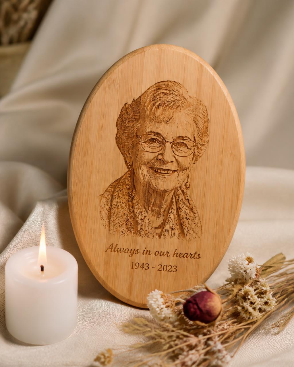 Oval bamboo memorial keepsake beside a candle