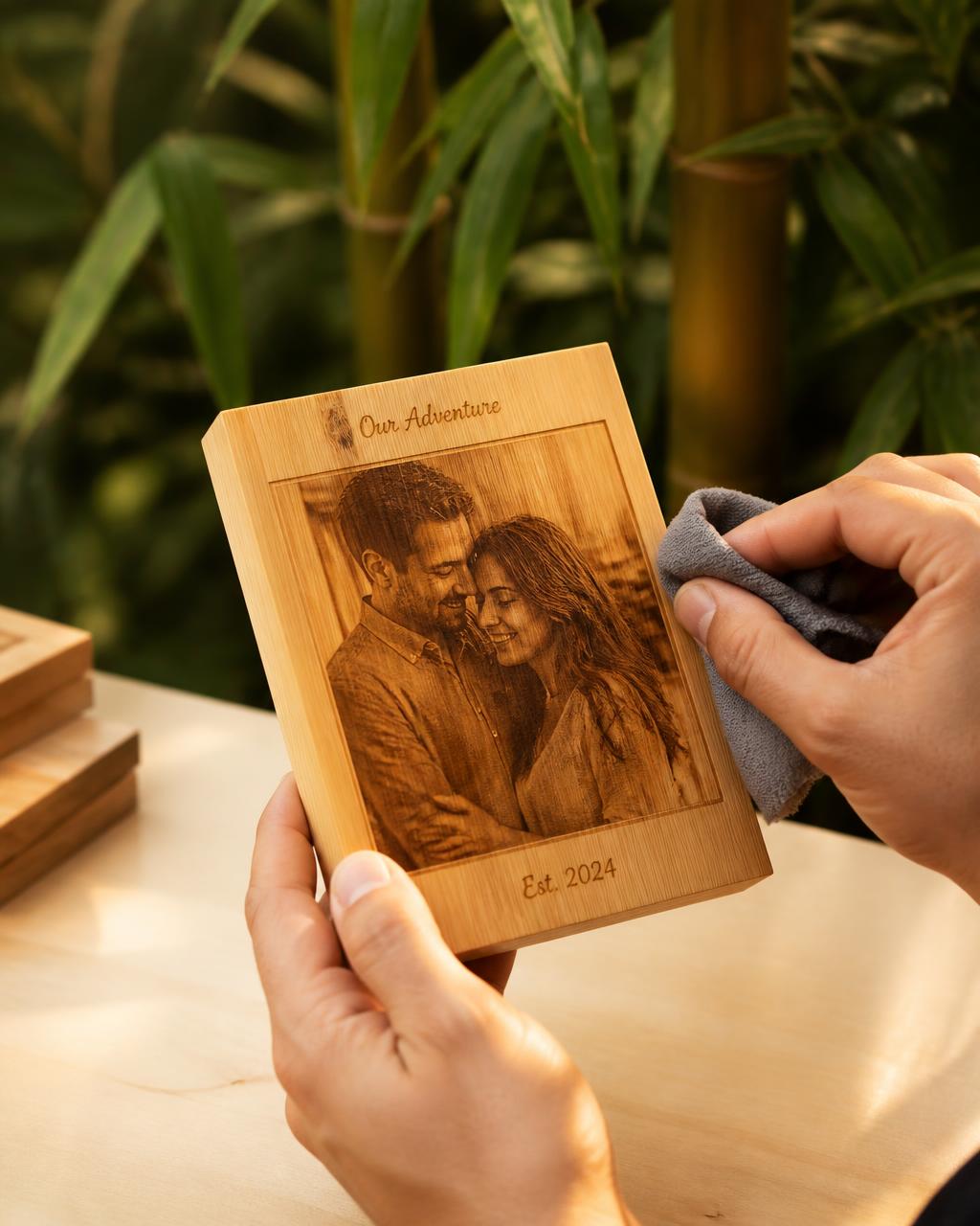 Hands polishing a finished engraved bamboo photo keepsake